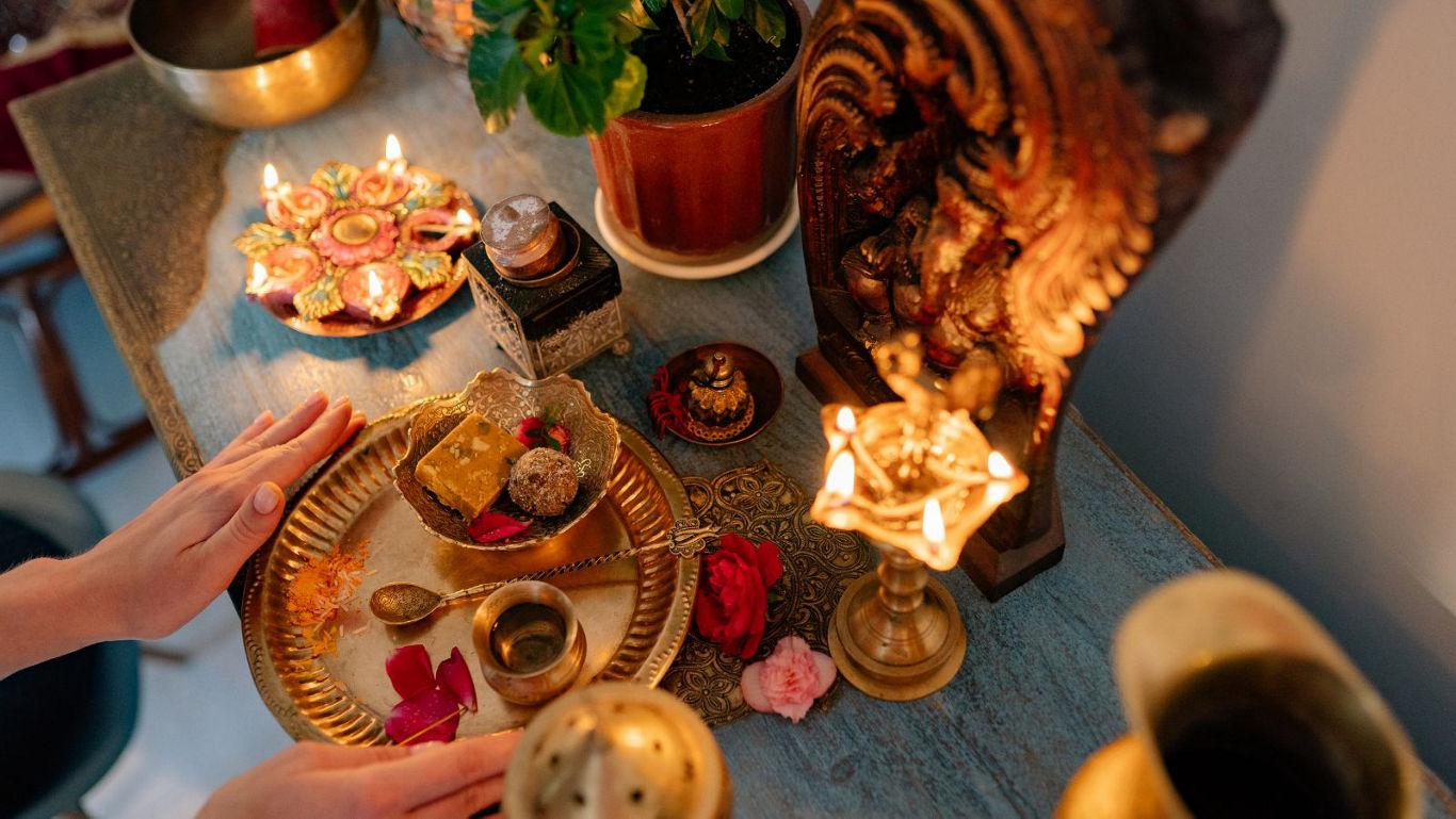Traditional Hindu prayer setup with diya lamps