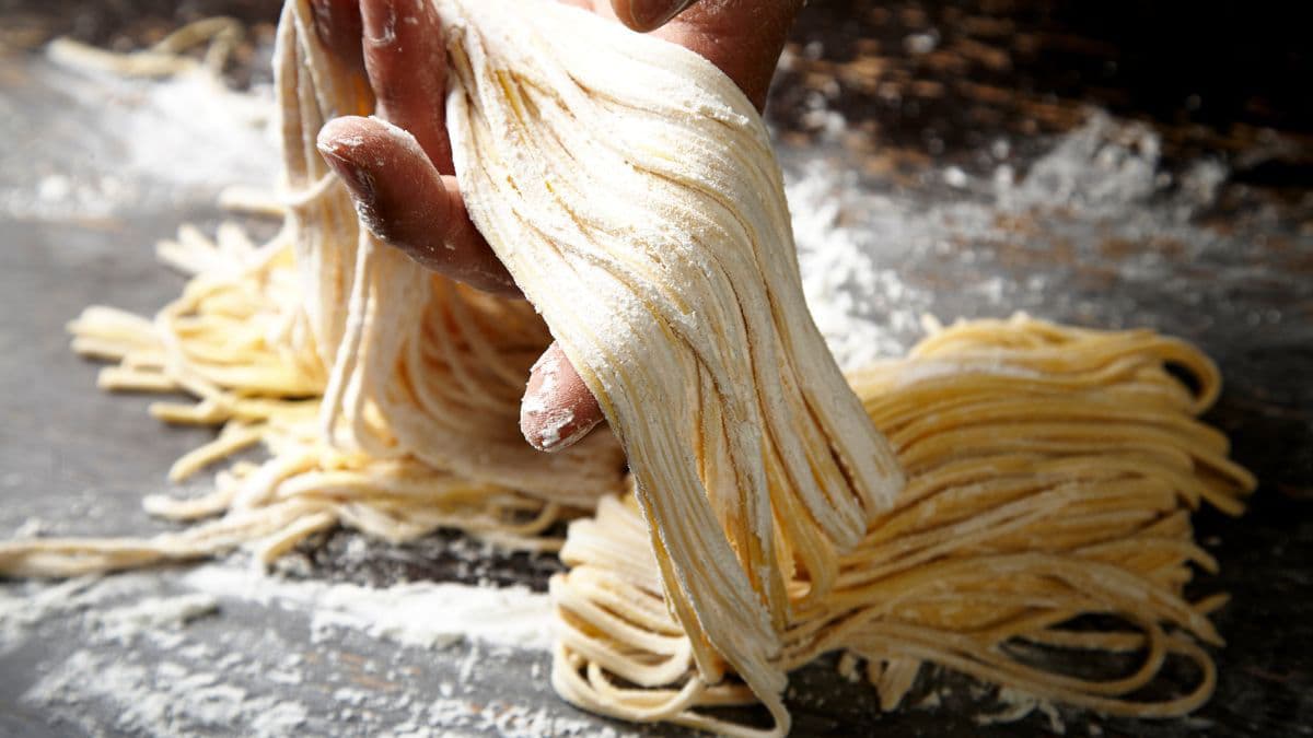 khapli wheat noodle strands dusted with flour