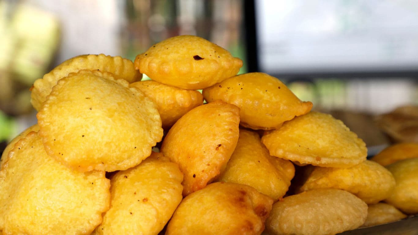 Golden fried pastries stacked in pile