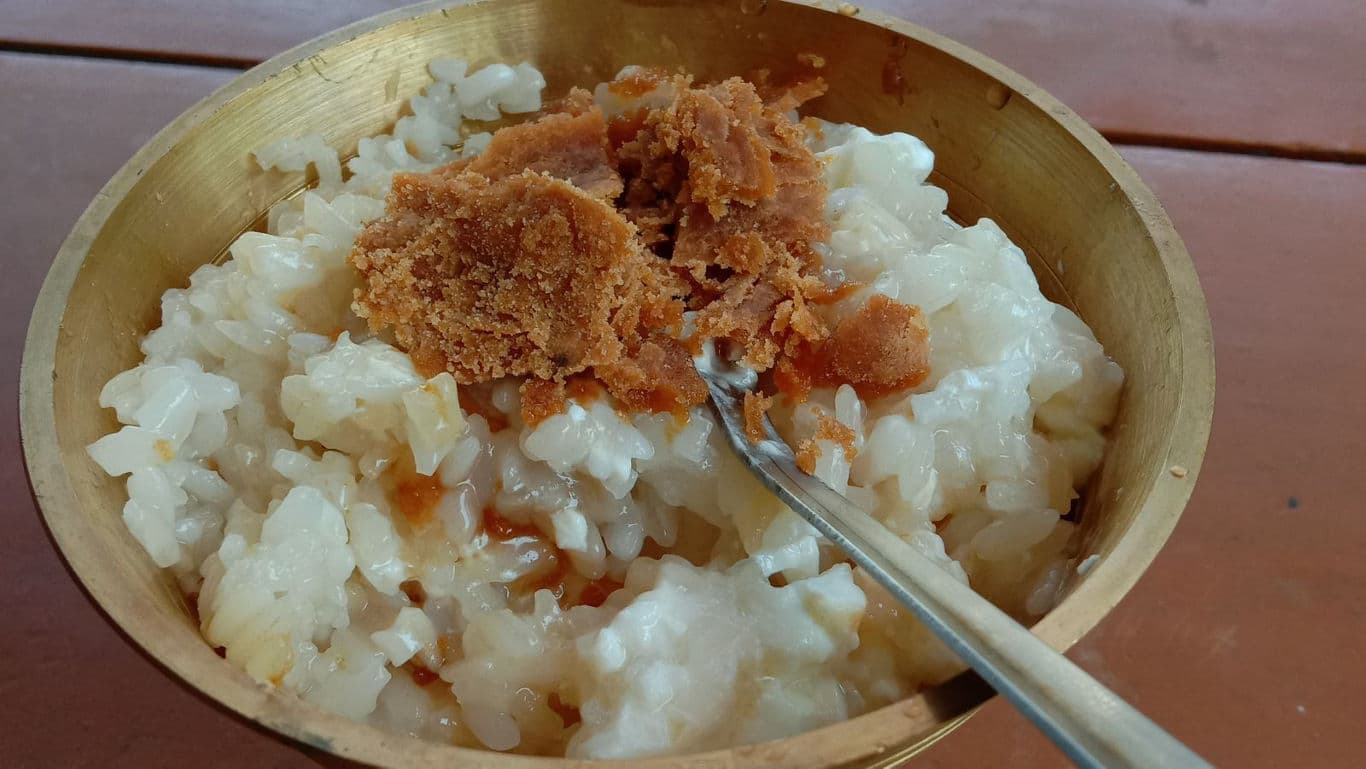 Rice Porridge with Brown Sugar in Wooden Bowl