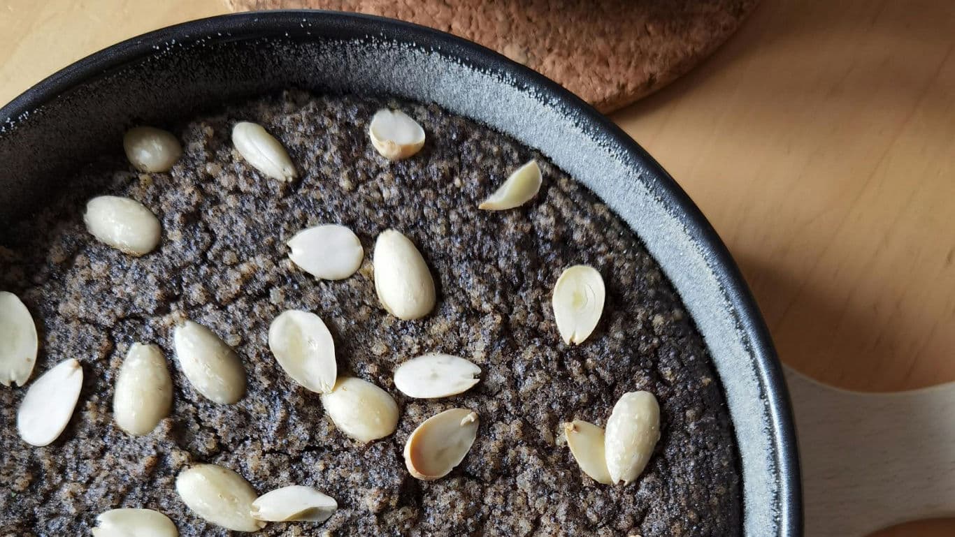 Skillet dessert topped with sliced almonds