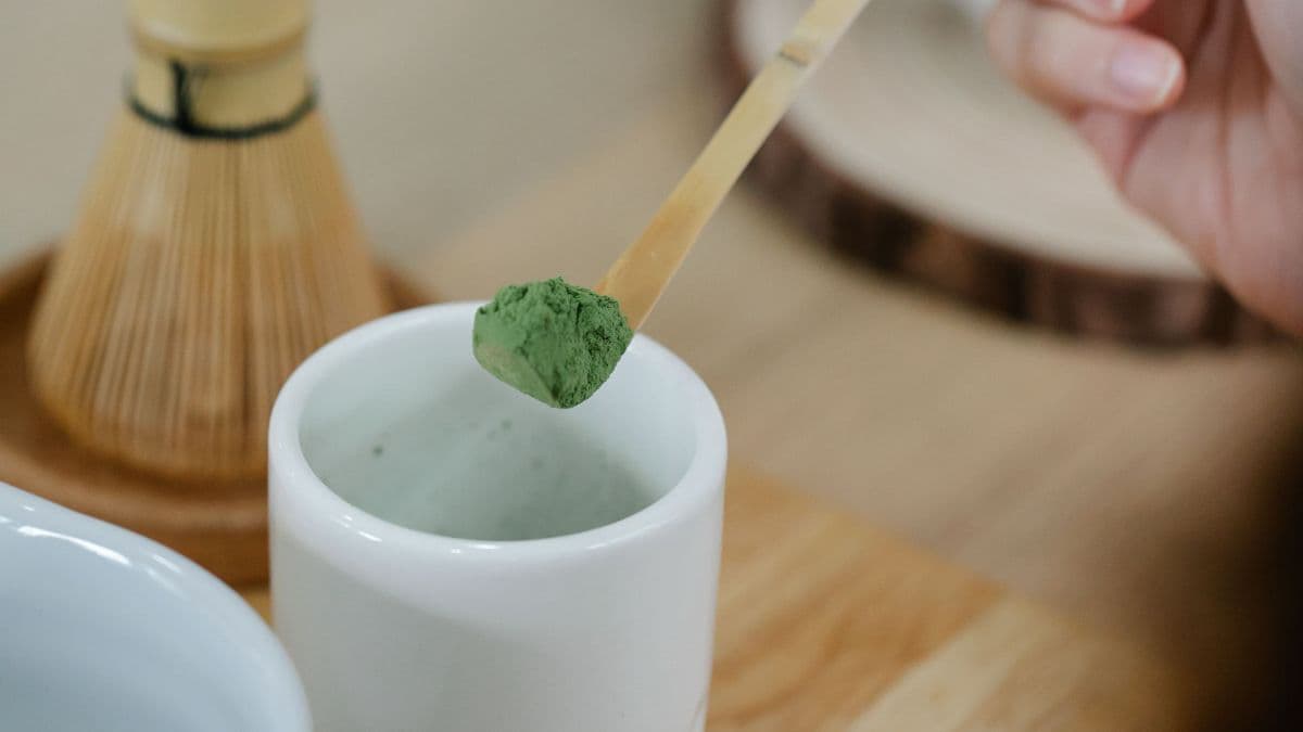 Matcha tea powder with brewing equipment.