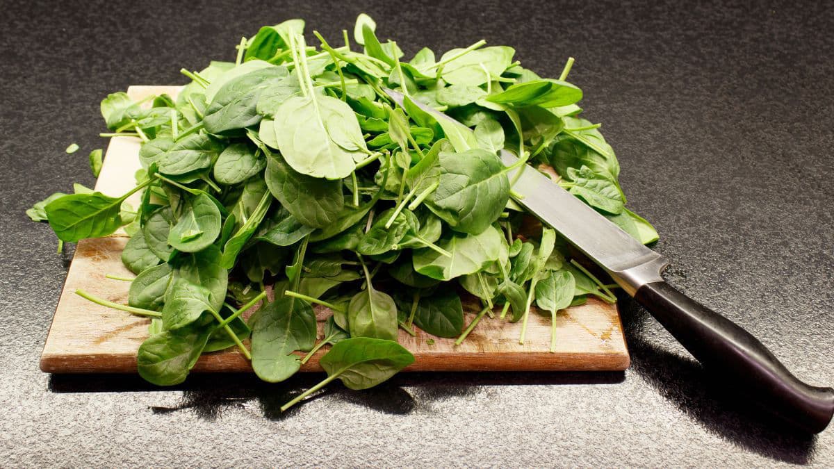 Fresh spinach on a wooden cutting board 