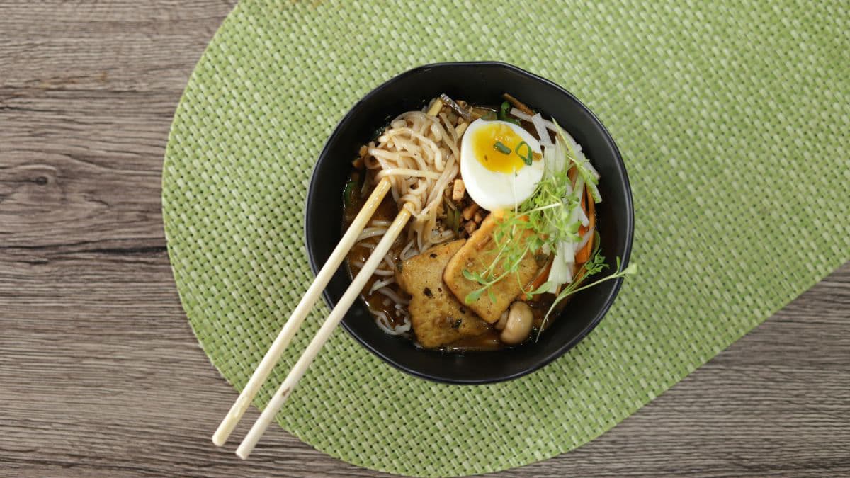 Classic egg ramen bowl with mushrooms and greens