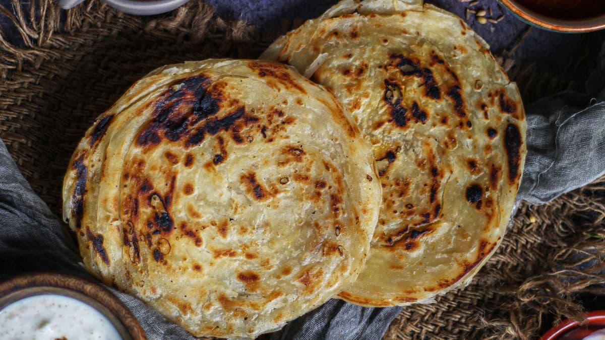 Flaky South Indian parotta stacked on a plate 