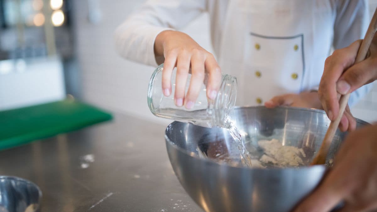 Adding lukewarm water to the dough