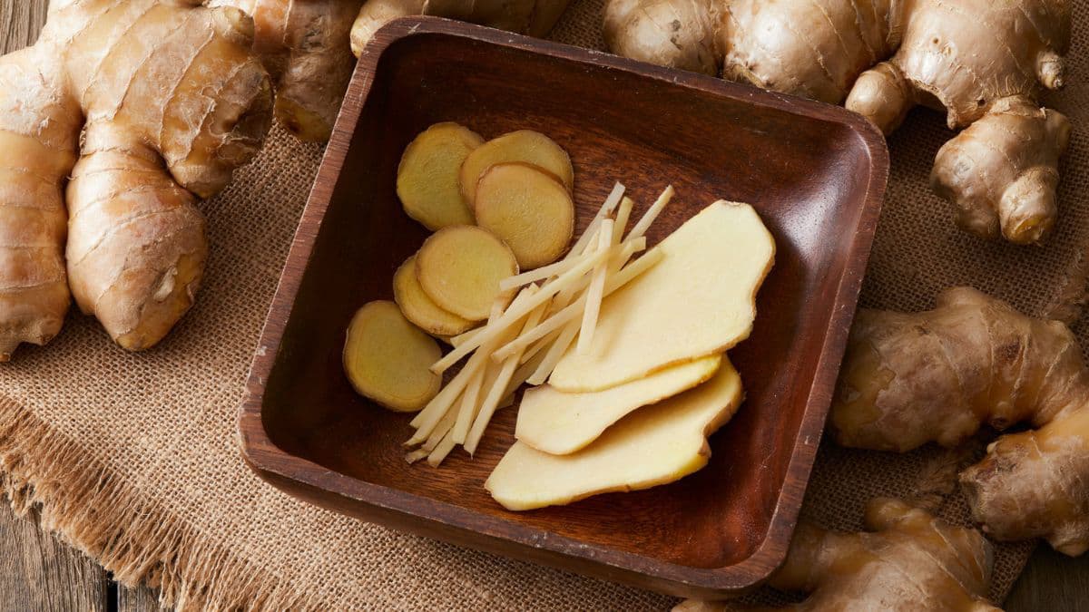 Whole ginger, sliced ginger in a bowl.