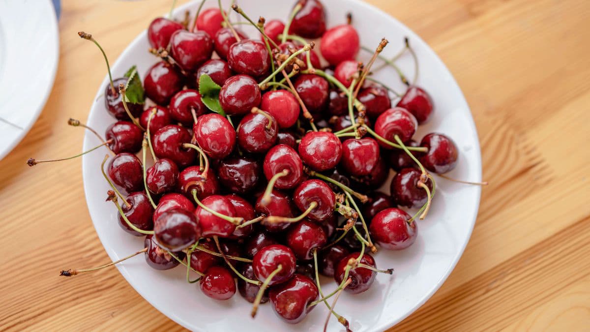 Fresh red cherries served on a white plate 
