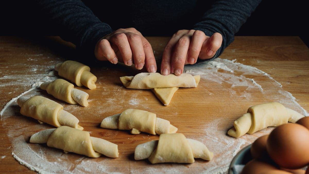Wrapping butter inside croissant dough layers 
