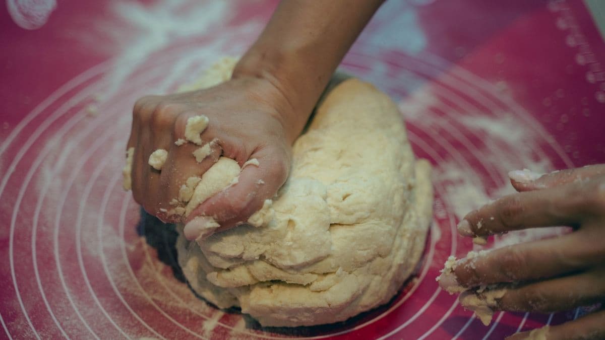 A person kneading dough
