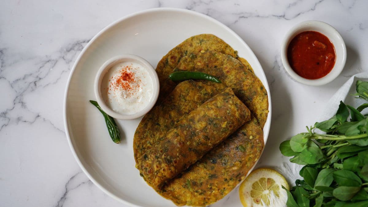 Methi Thepla on a plate with curd