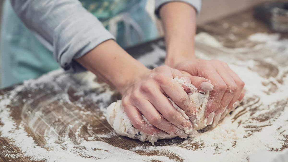 Person kneading smooth khapli wheat dough