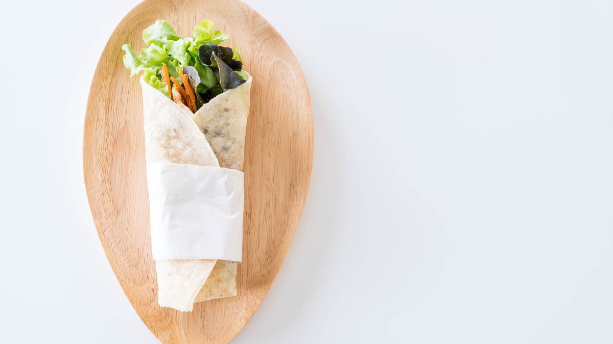 Chickpea salad wrap on a wooden table