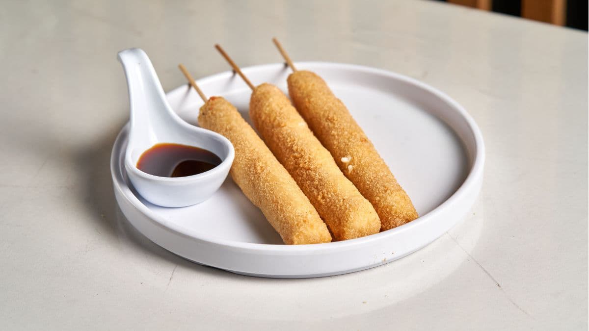 Cheesy corn dog on a plate