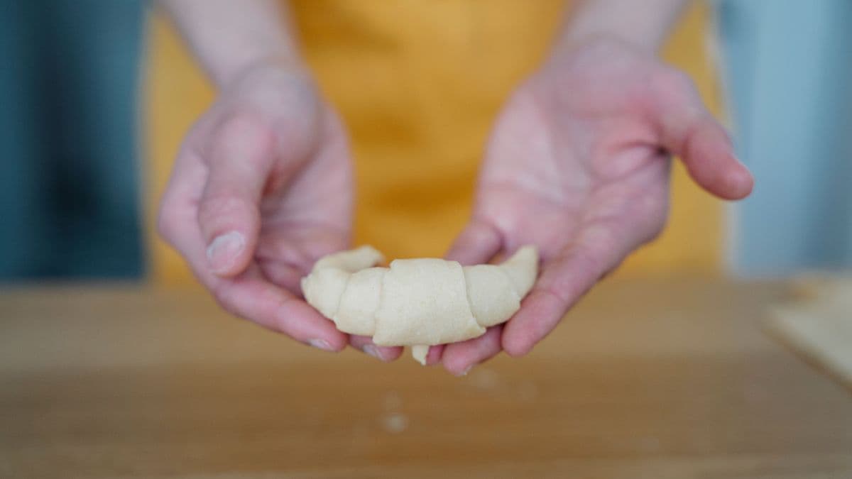 Shaping classic crescent butter croissants by hand