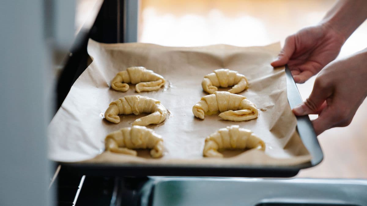 Proofed croissant dough rising on a baking tray