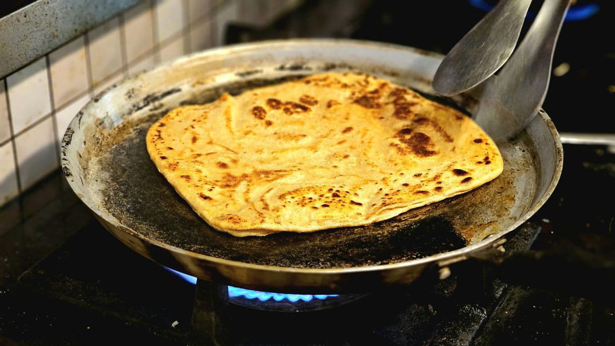 Aloo paratha on a tawa.