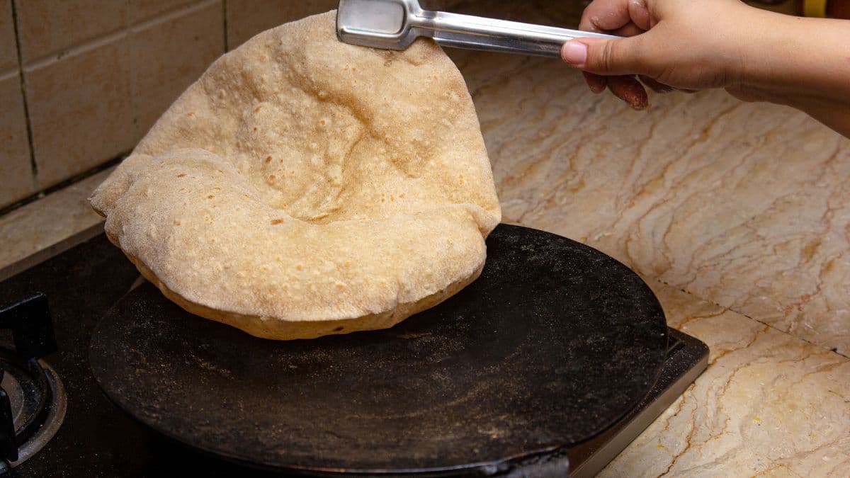 Cooking roti on a hot tawa 