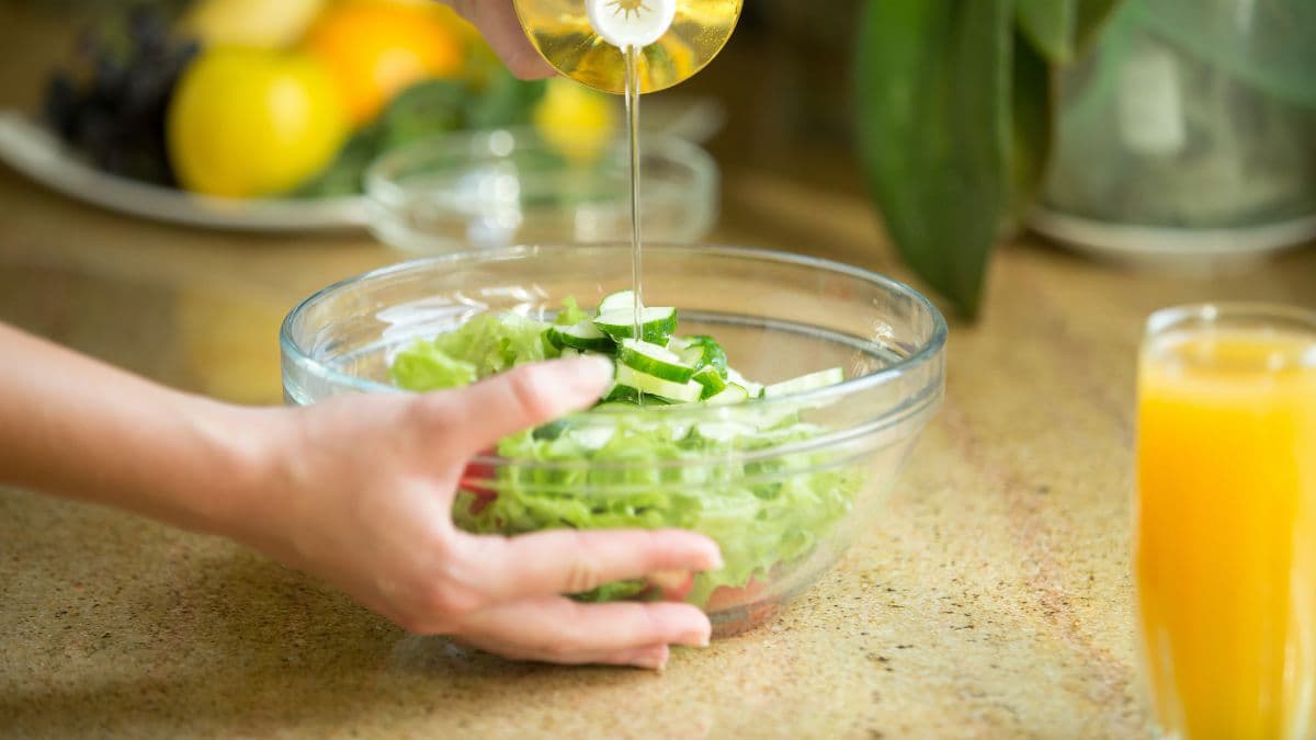 Pouring oil in a salad