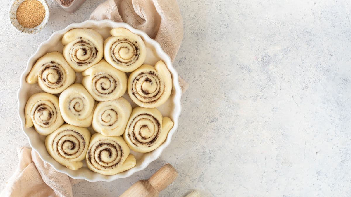 Sliced cinnamon roll dough arranged for baking 