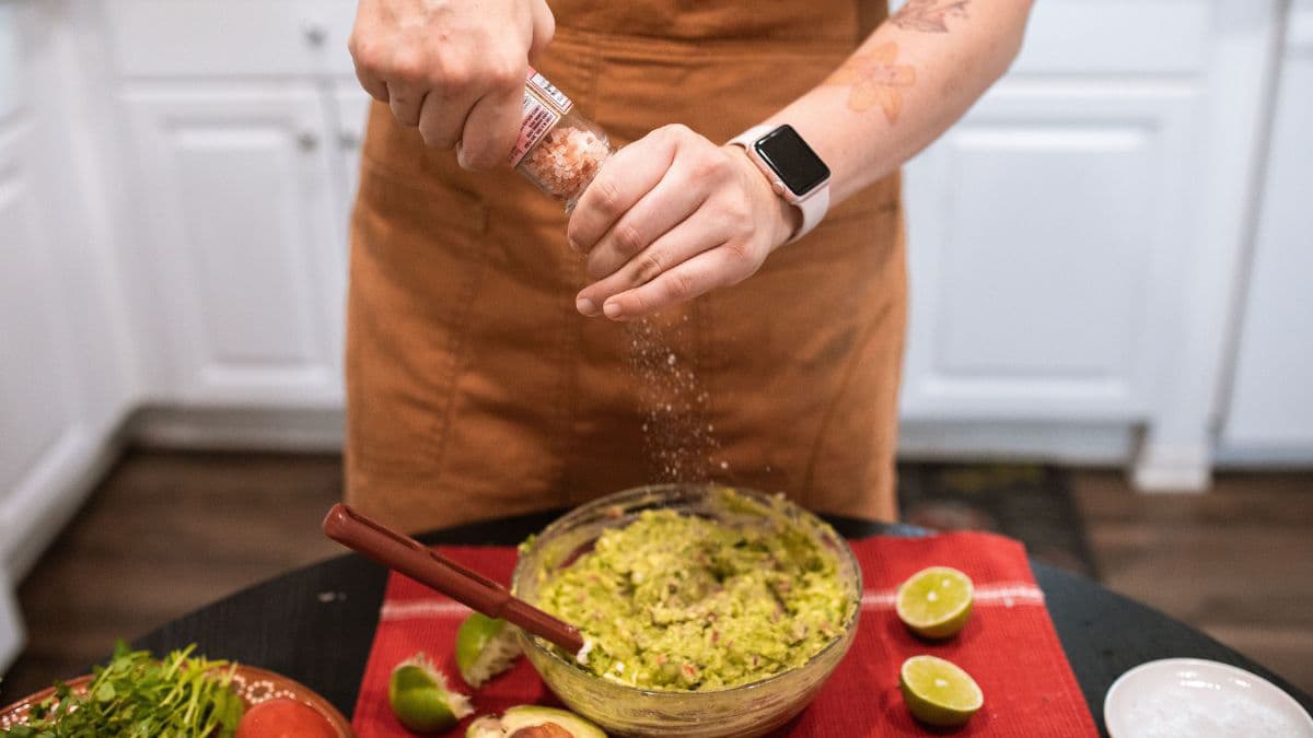 Seasoning guacamole with salt and coriander