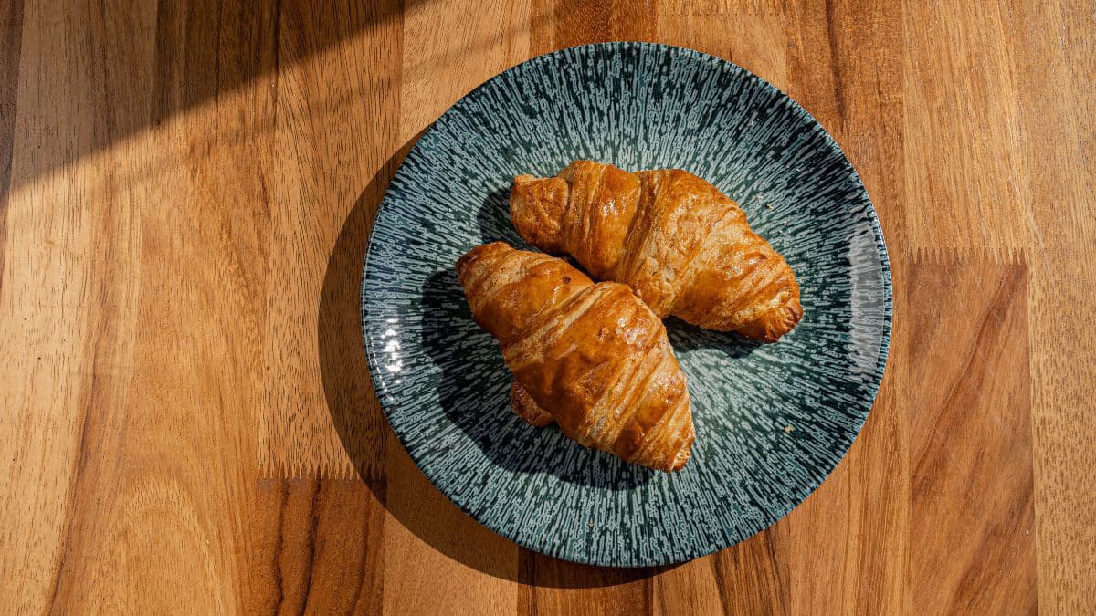 Freshly baked butter croissants with golden crust 