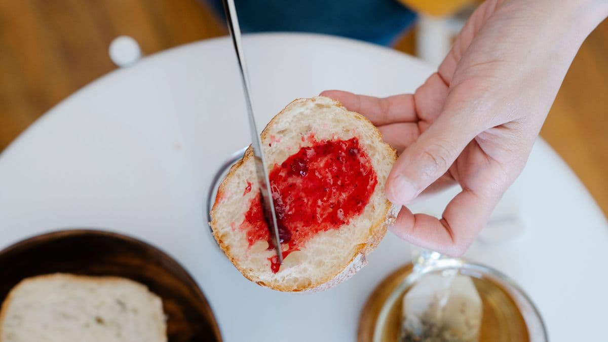 Jam getting spread on bread