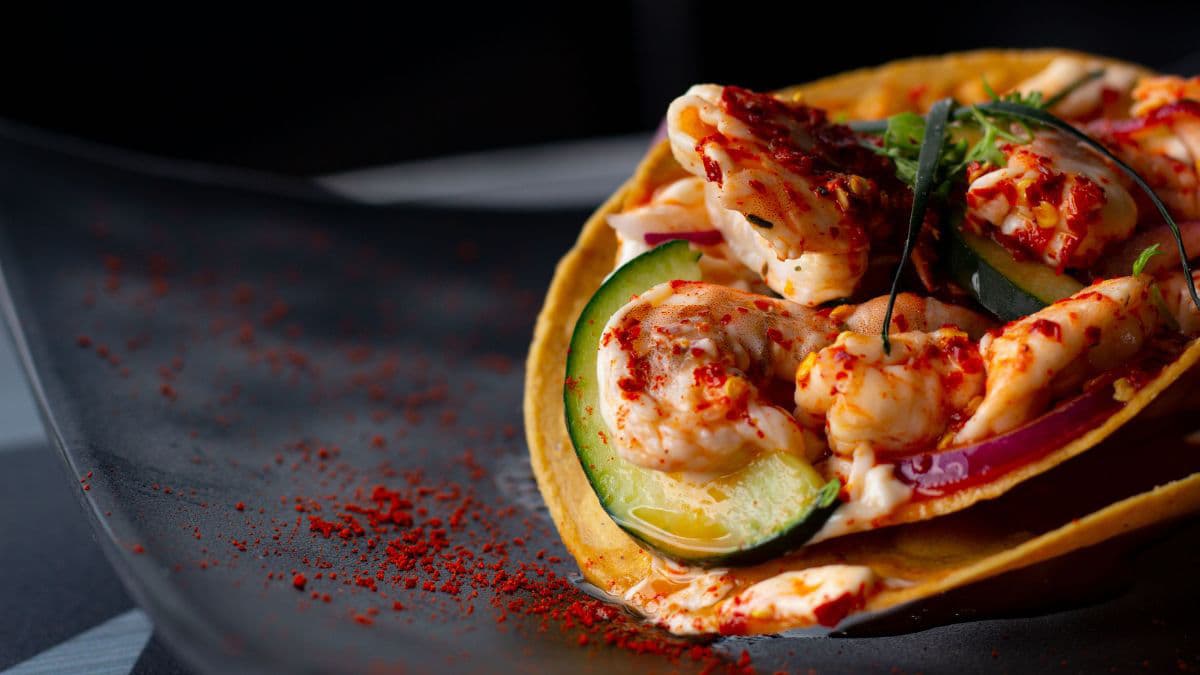 Saucy shrimp tacos on a plate.