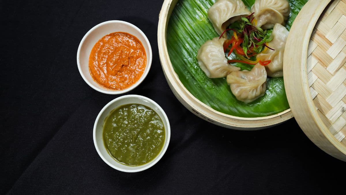 Dipping sauces beside momos.