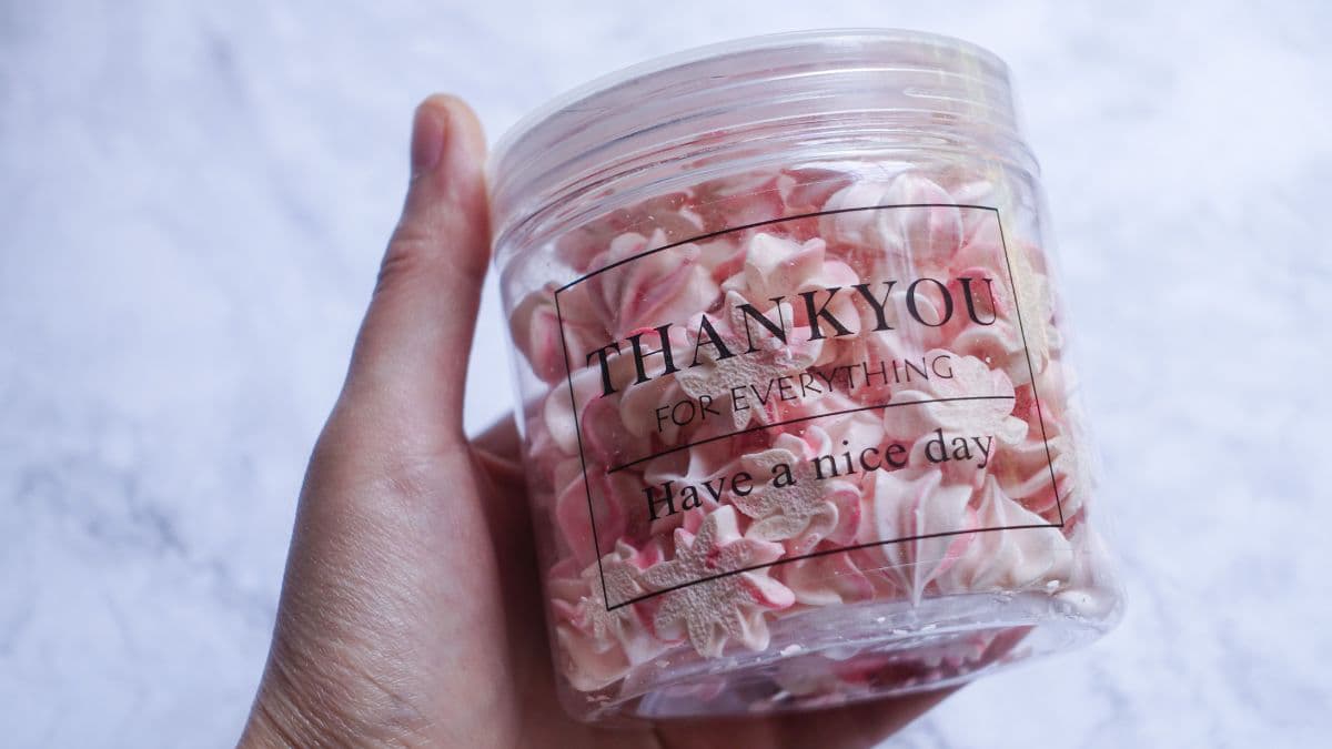 Meringue swirl cookies stored in an airtight container.
