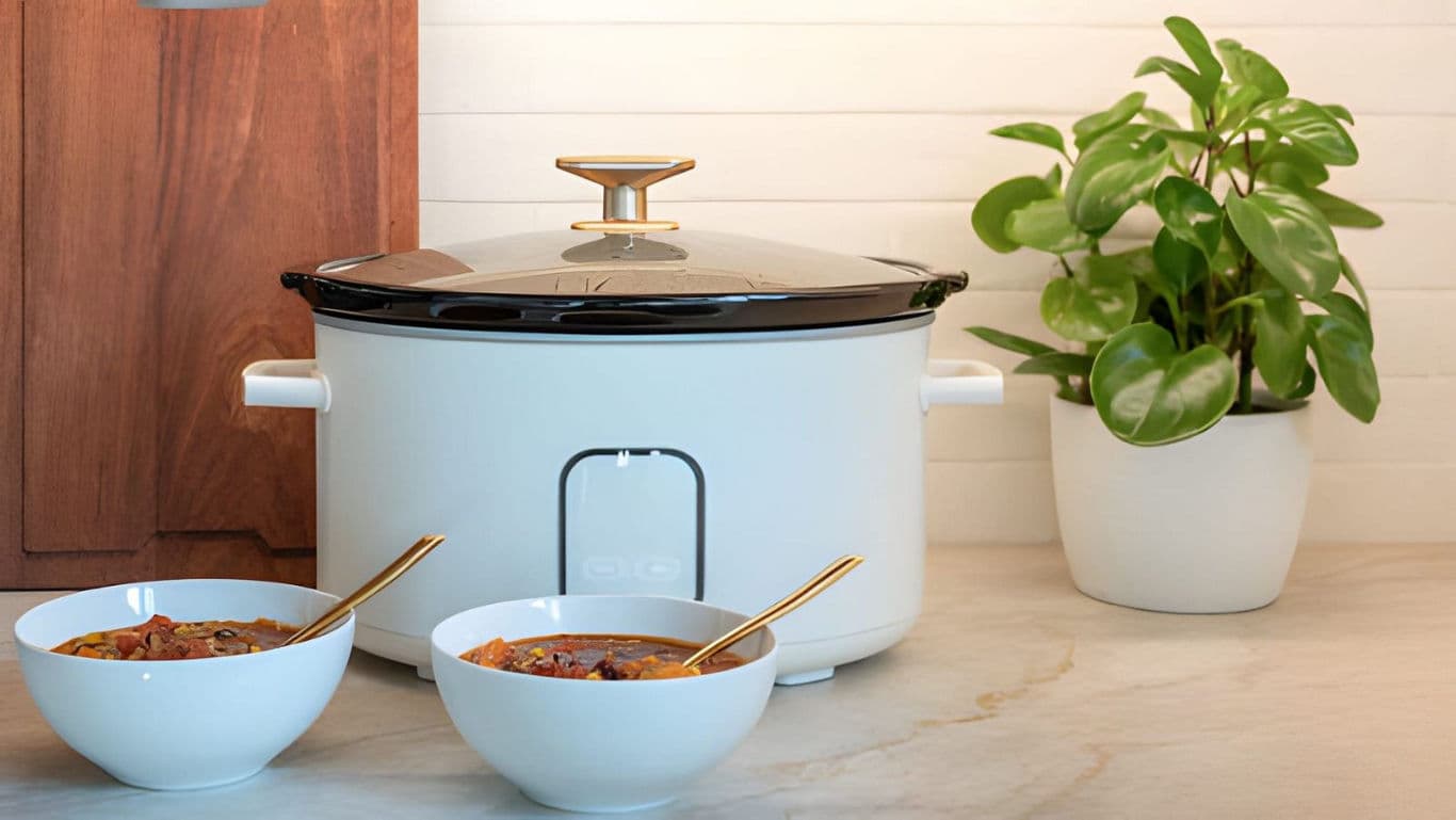 Slow cooker with bowls of meat curry.