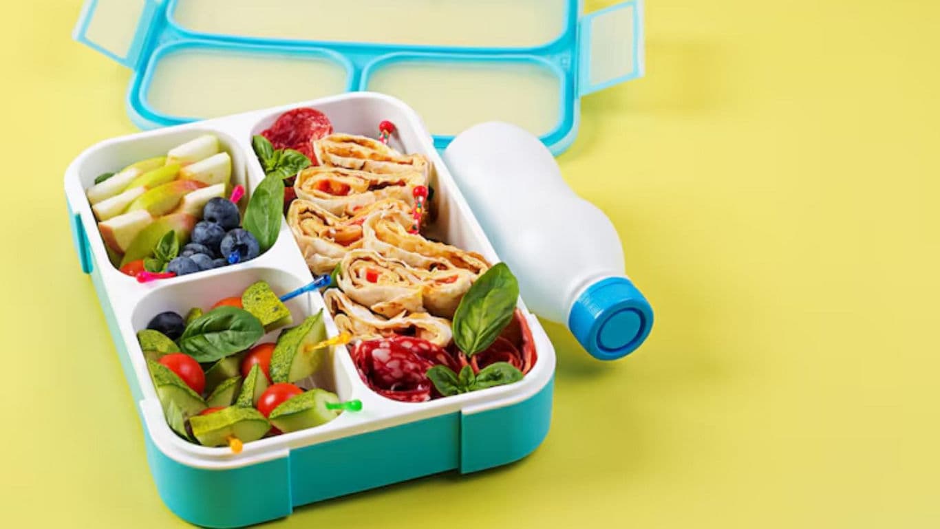 Colorful healthy lunchbox with wrap and fruit
