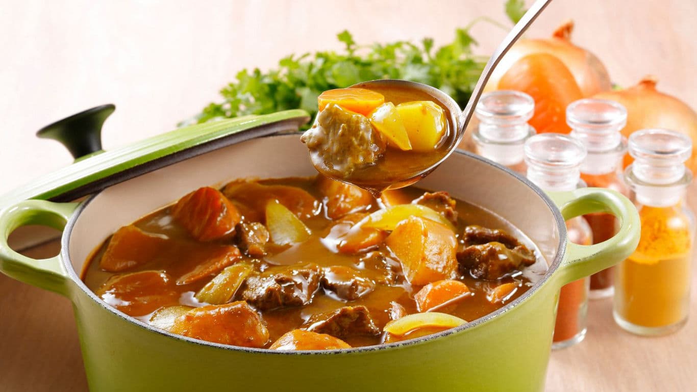 Hearty stew in green cookware