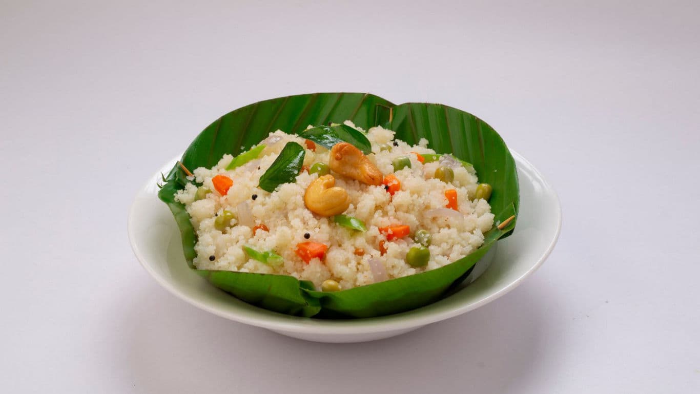 Vegetable upma served on banana leaf in bowl