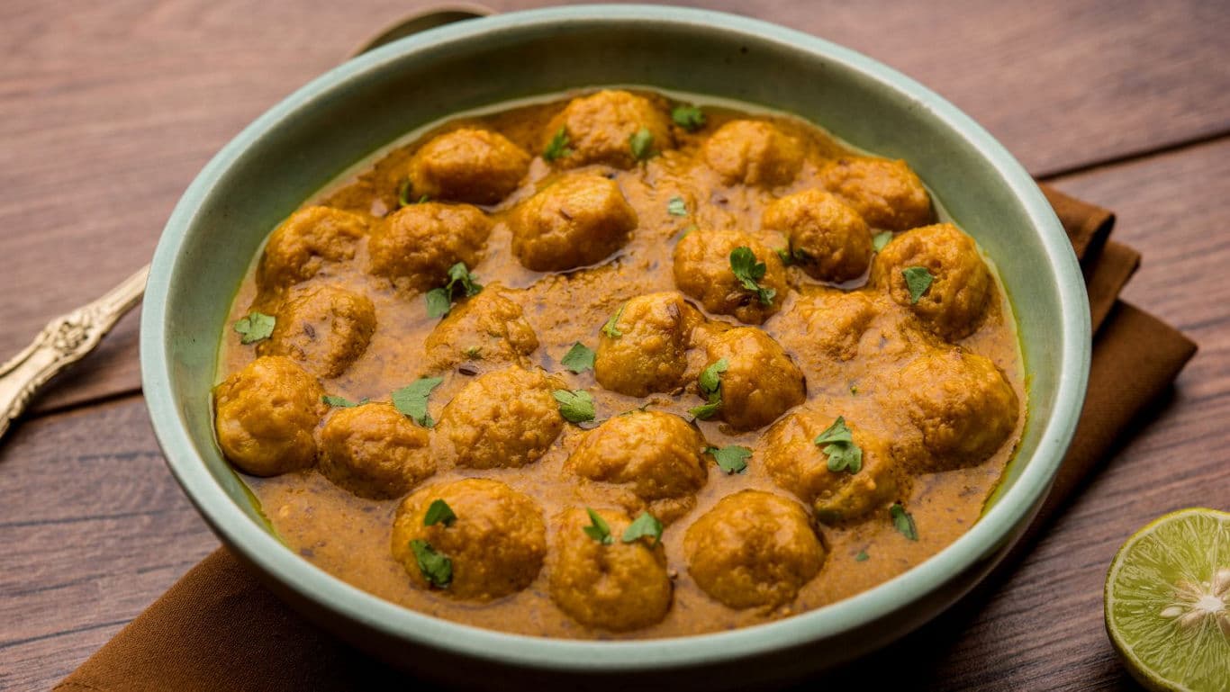 Bowl of Indian kofta curry with fresh garnish