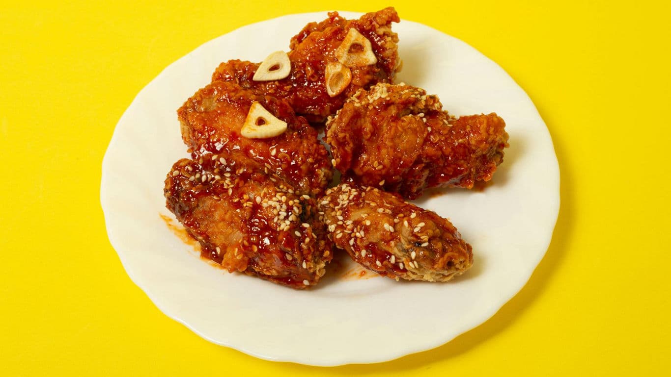 Crispy glazed fried chicken wings on plate