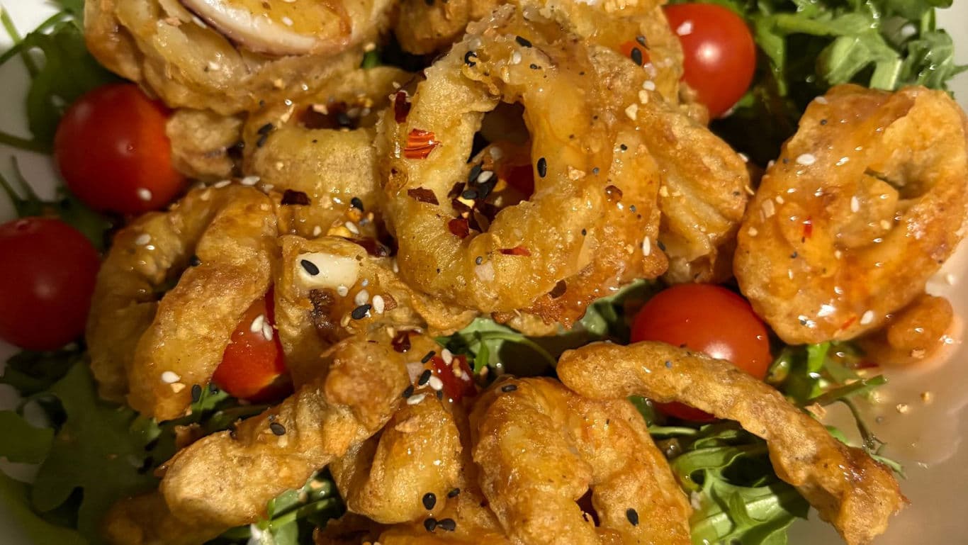 Crispy fried calamari salad with cherry tomatoes