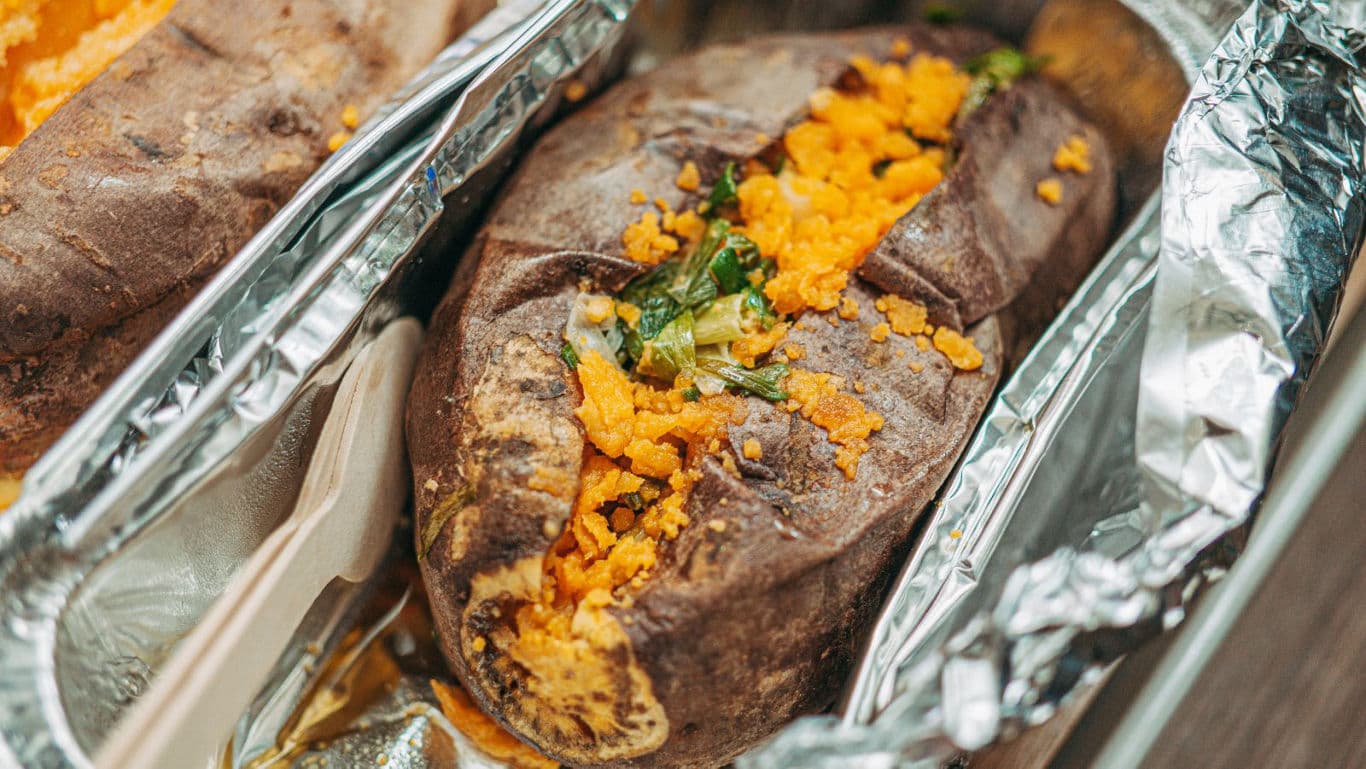 Baked sweet potato stuffed with toppings