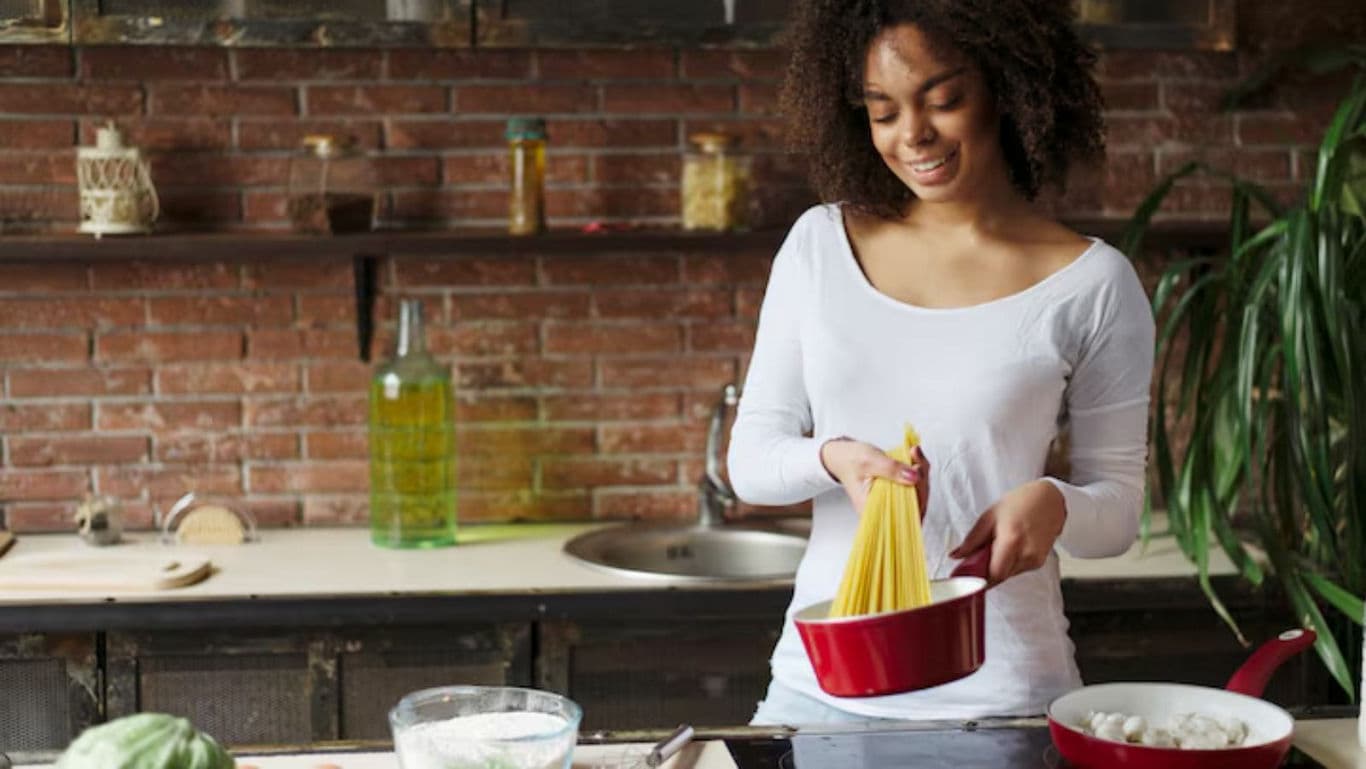 Woman Preparing Pasta in Rustic Kitchen Setting