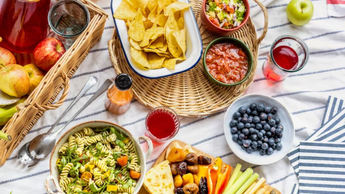 Colorful picnic spread with fresh fruits and snacks
