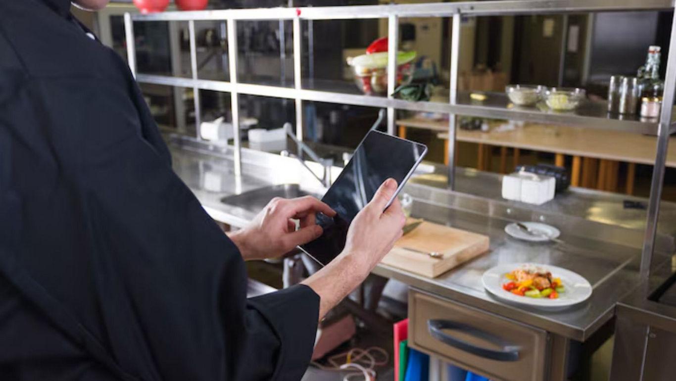 Chef using tablet in professional kitchen