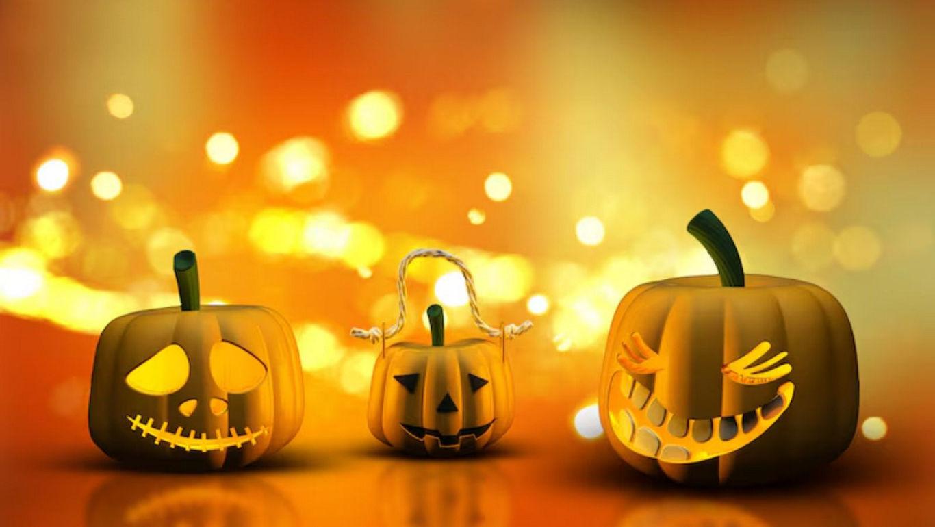 Carved pumpkins with glowing faces on orange background