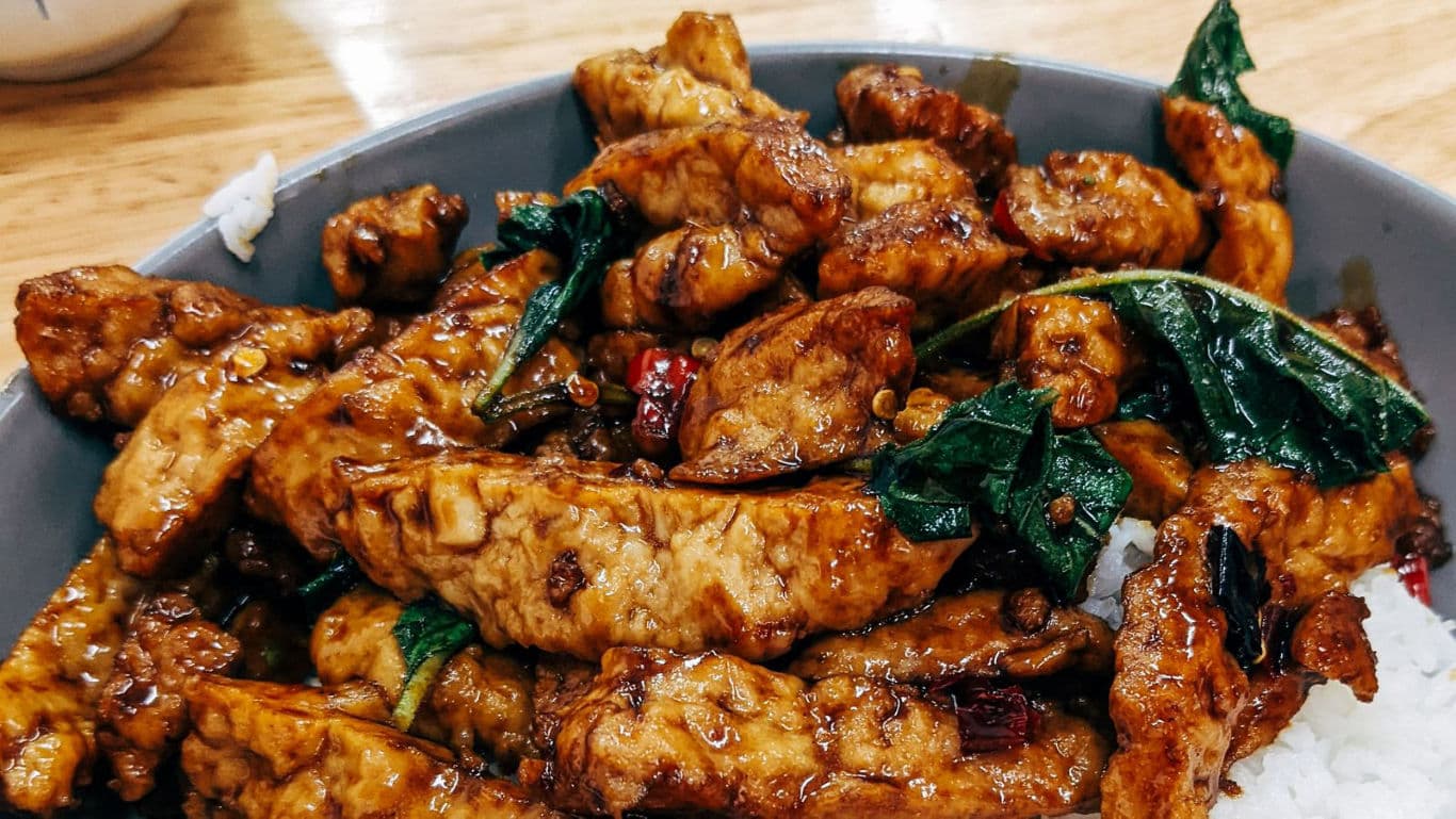 Stir-fried glazed chicken with basil over rice