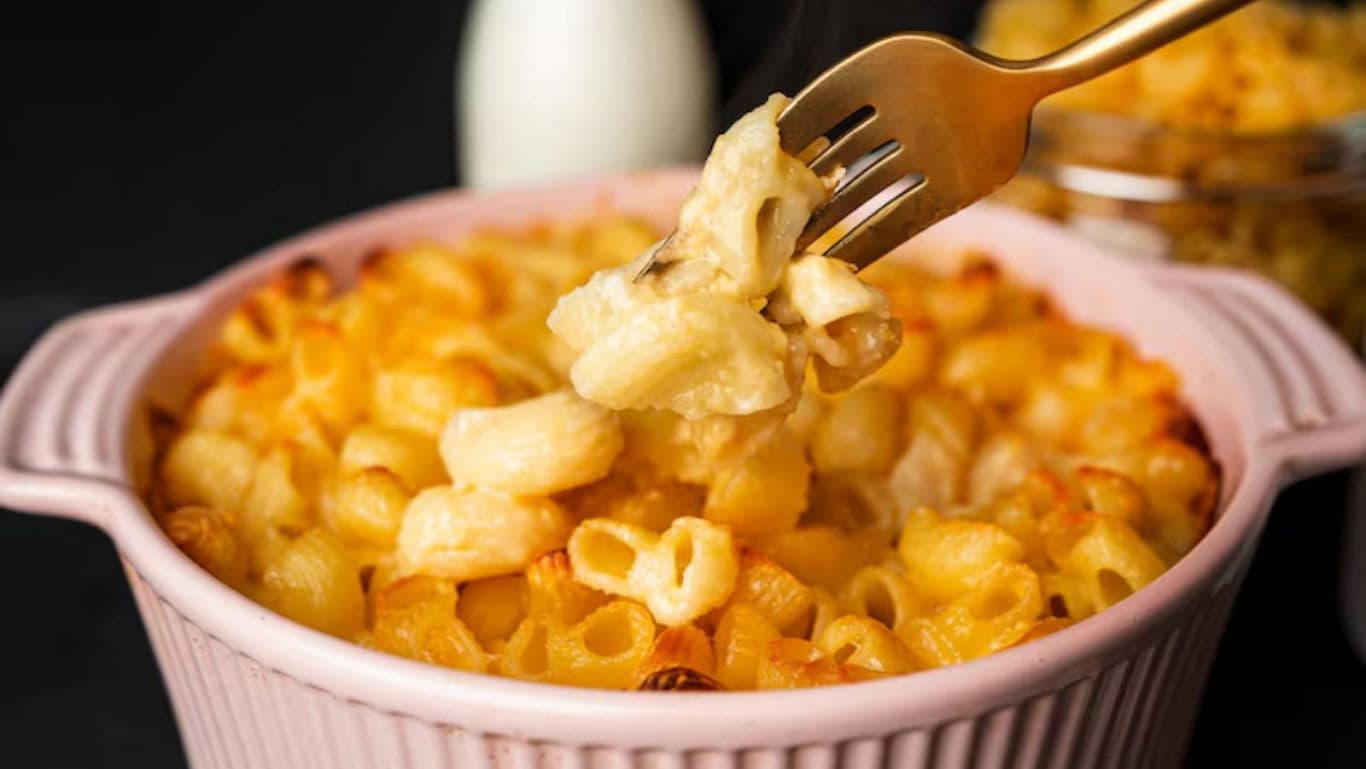 Creamy baked macaroni and cheese in pink dish