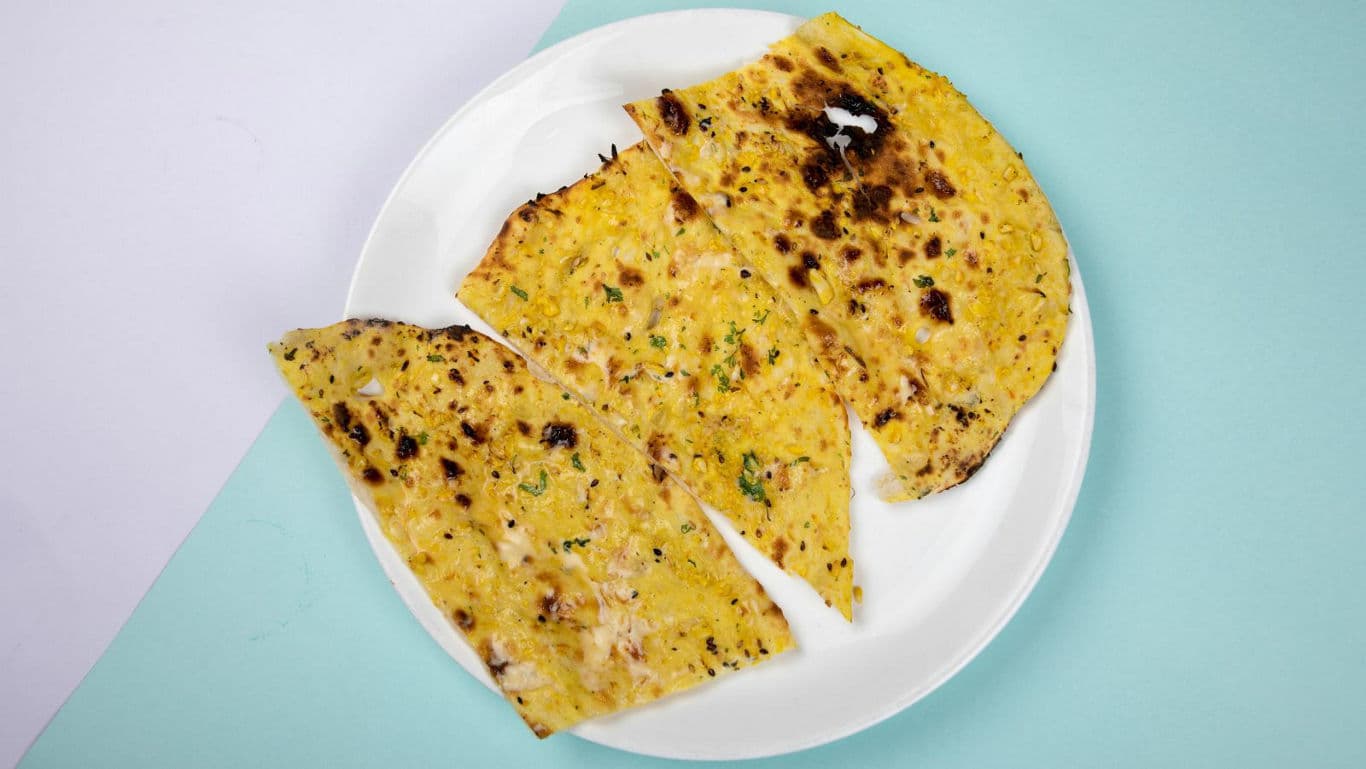 Grilled flatbread pieces on white plate
