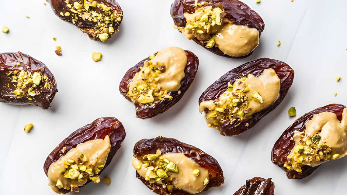 Stuffed dates with nut butter and pistachio topping