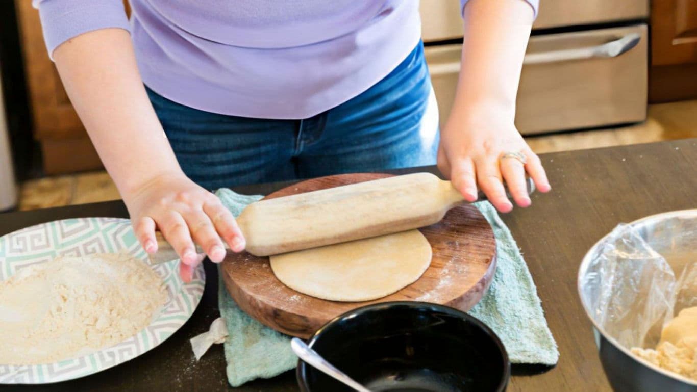 Stuffed paratha being rolled