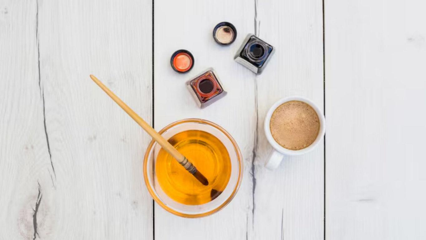 Art supplies with coffee on wooden table