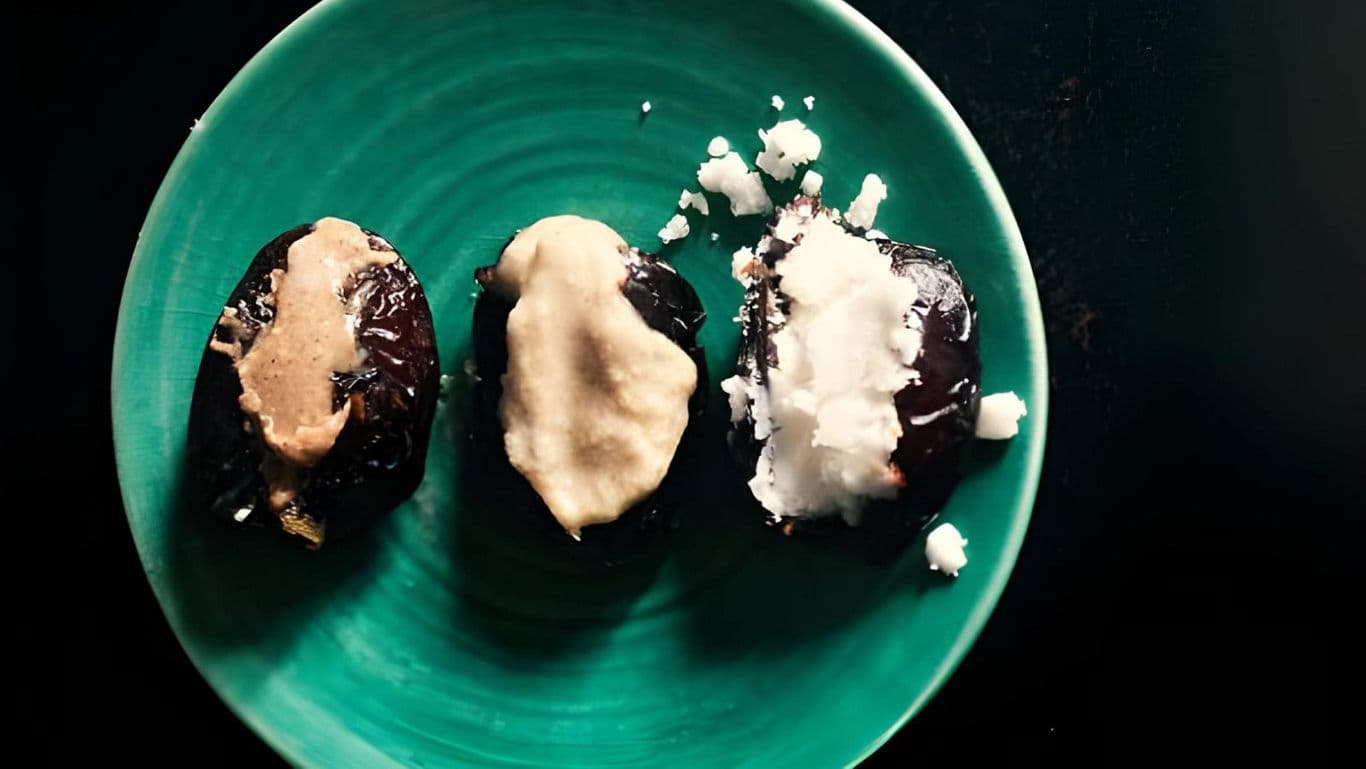 Stuffed Dates with Nut Butter and Coconut on Plate