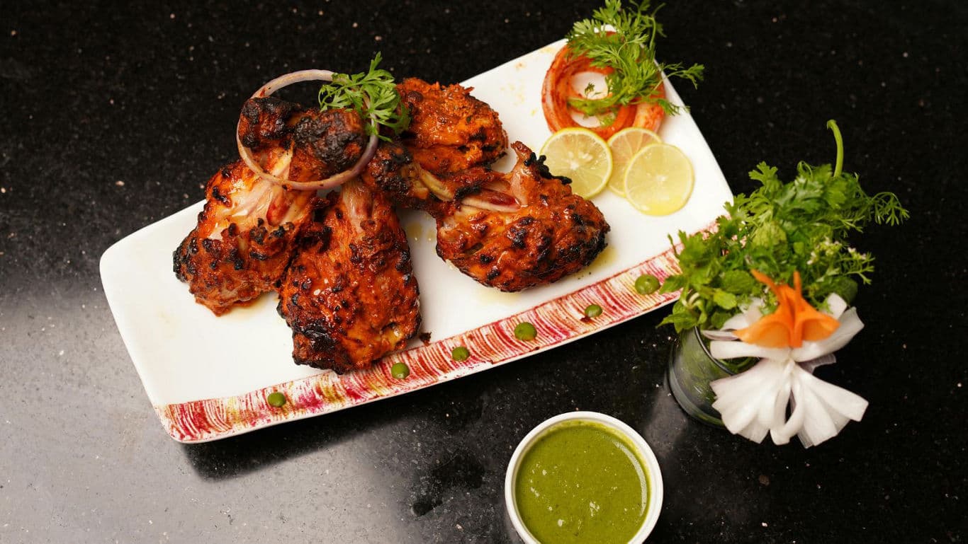 Grilled tandoori chicken with chutney and salad